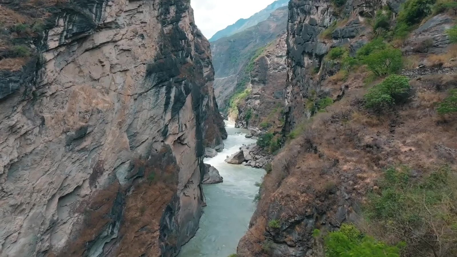 A river flowing between the steep rock walls of a Yunnan gorge