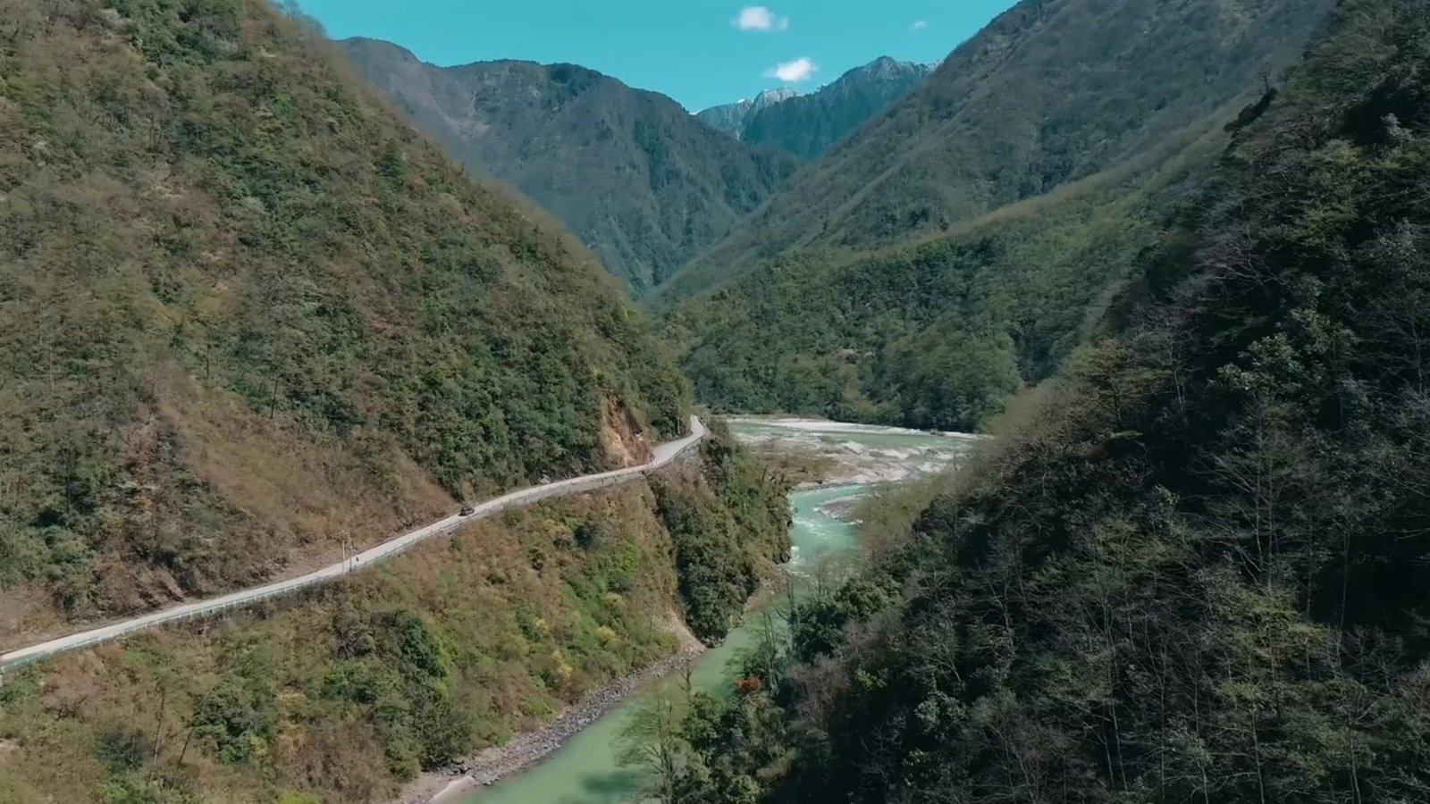 A winding road beside a river in the mountains of Yunnan