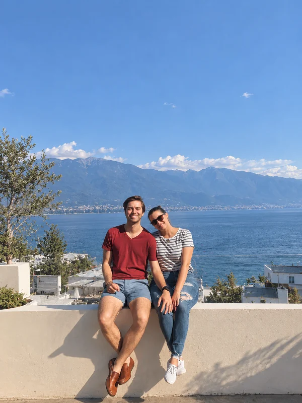Couple sitting together beside a mountain lake