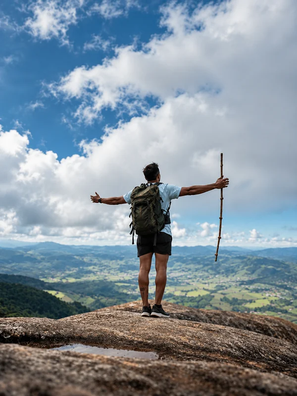 Solo hiker looking out across a mountain valley